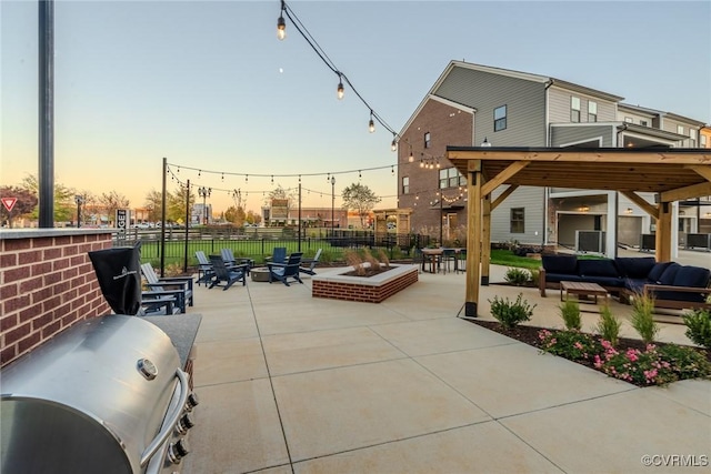 patio terrace at dusk featuring an outdoor living space