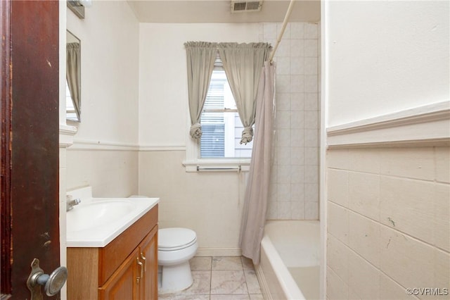 full bathroom with shower / bathtub combination with curtain, vanity, and toilet