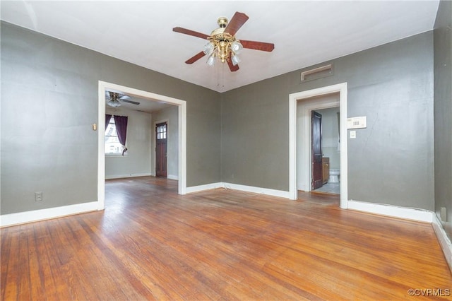 spare room with wood-type flooring and ceiling fan