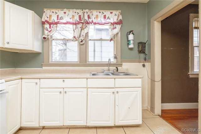 kitchen featuring white cabinetry, sink, and a healthy amount of sunlight