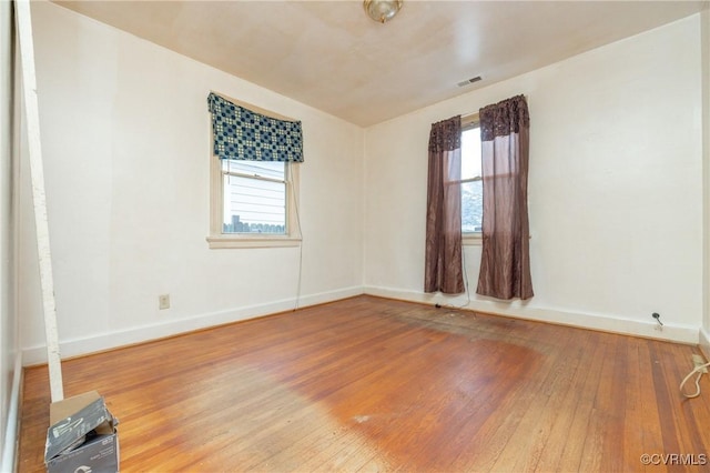 unfurnished room featuring hardwood / wood-style floors and a wealth of natural light