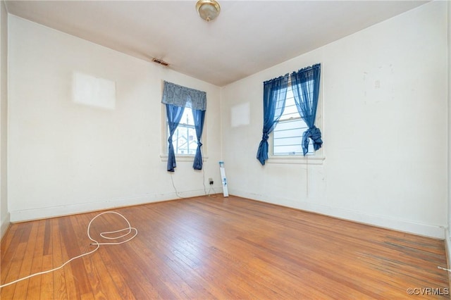 empty room with hardwood / wood-style flooring