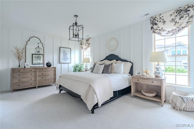 bedroom with a notable chandelier and carpet