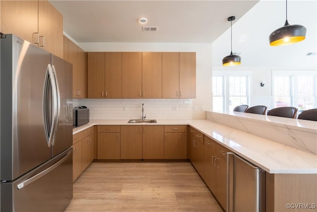 0 Canoe Pointe Loop, Moseley, VA 23120 - kitchen with freestanding refrigerator, a sink, a peninsula, light wood-style flooring, and backsplash