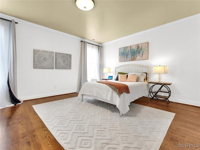 bedroom featuring crown molding and light hardwood / wood-style floors