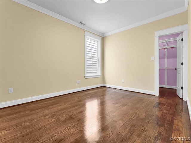 unfurnished room featuring ornamental molding and dark hardwood / wood-style flooring