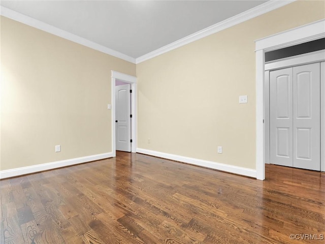 spare room with wood-type flooring and ornamental molding