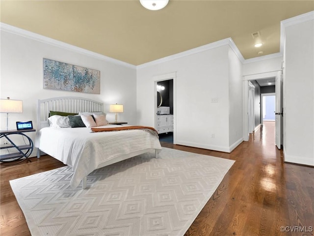 bedroom with hardwood / wood-style flooring, ornamental molding, and ensuite bathroom