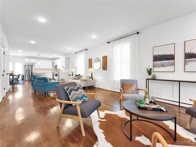 living room featuring hardwood / wood-style flooring and baseboard heating