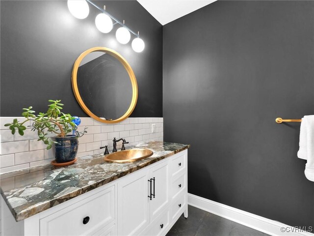 bathroom with tile patterned floors, vanity, and decorative backsplash