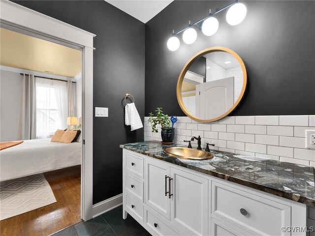 bathroom featuring vanity, wood-type flooring, and backsplash