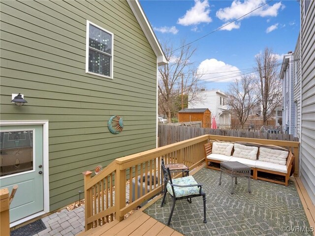 deck with an outdoor living space and a patio