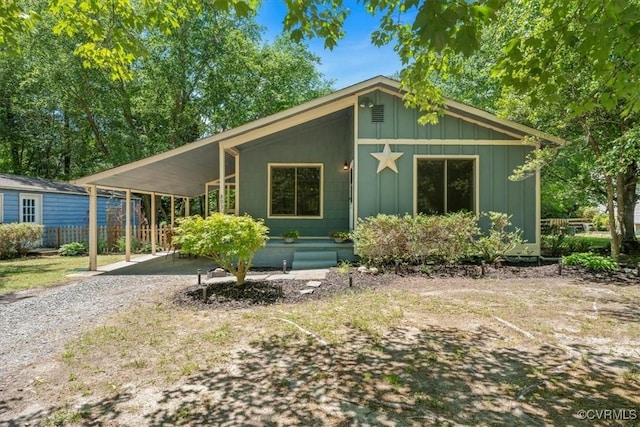 803 Lake Caroline Dr, Abingdon, VA 22546 - mid-century home with board and batten siding, a carport, and gravel driveway
