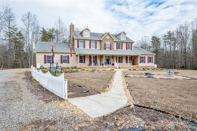 view of front of house featuring covered porch and a chimney