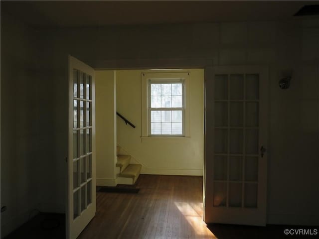 hallway featuring french doors and dark hardwood / wood-style floors