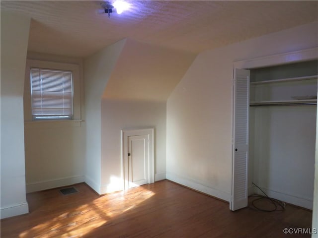 unfurnished bedroom with wood-type flooring and a closet