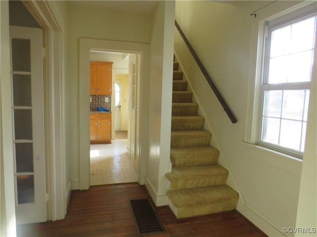 stairway featuring wood-type flooring