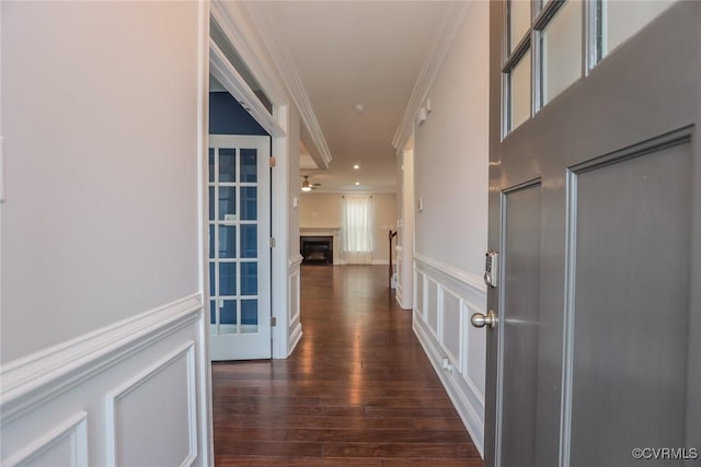 hallway featuring ornamental molding and dark hardwood / wood-style flooring