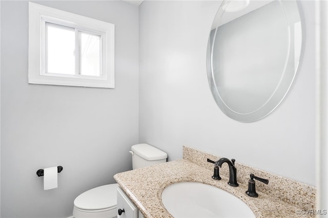 bathroom with toilet and vanity