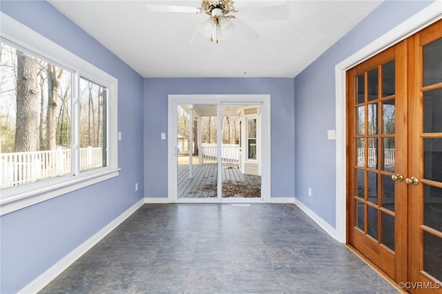 unfurnished room featuring a ceiling fan, french doors, and baseboards