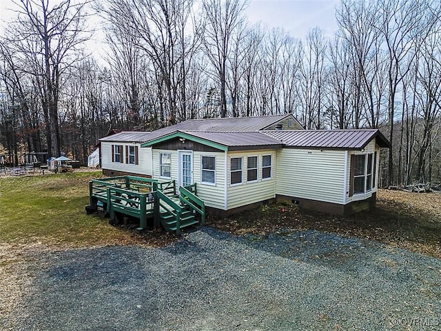 manufactured / mobile home with metal roof and driveway