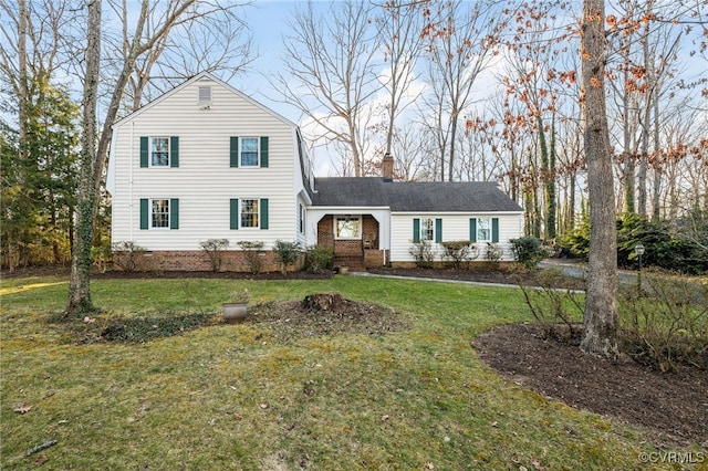 view of front of home with a chimney and a front lawn