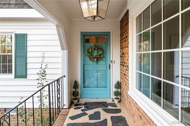 entrance to property featuring brick siding