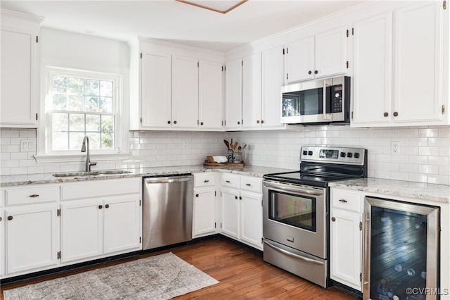 kitchen featuring white cabinets, wine cooler, and stainless steel appliances