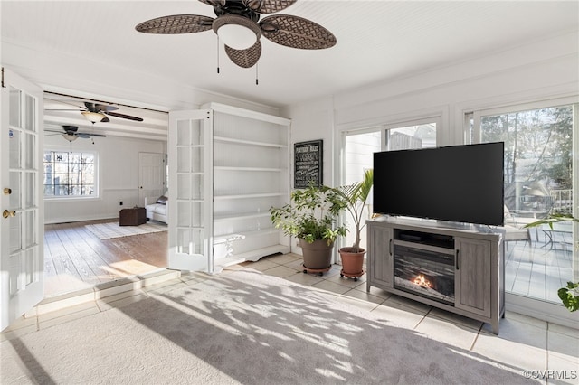 living room featuring french doors and a glass covered fireplace