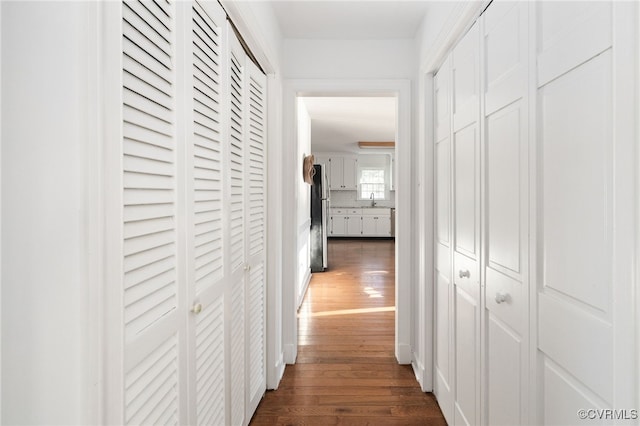 hallway with dark wood-type flooring