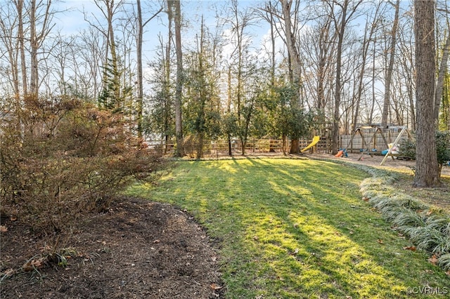 view of yard with a playground and fence