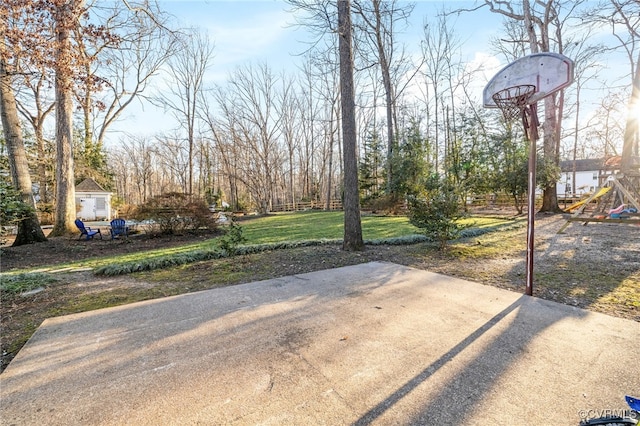 view of yard featuring basketball hoop