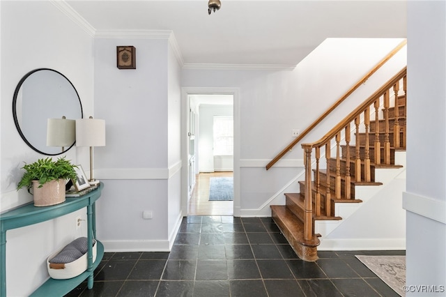 foyer with ornamental molding, stairway, and baseboards