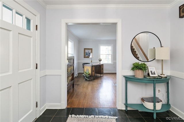 foyer featuring ornamental molding, dark wood-style flooring, and baseboards