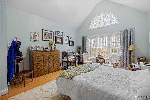 bedroom featuring hardwood / wood-style floors and high vaulted ceiling