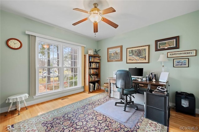 home office featuring hardwood / wood-style floors and ceiling fan