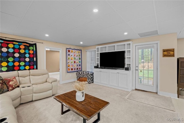 living room featuring light colored carpet and a drop ceiling