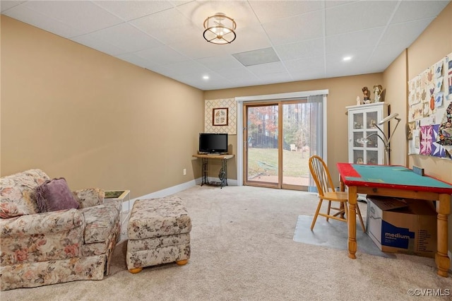 recreation room with a paneled ceiling and carpet floors