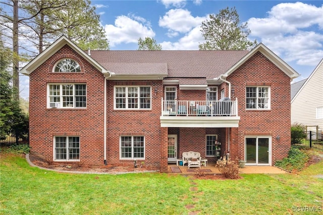 back of house featuring a patio, a balcony, and a yard