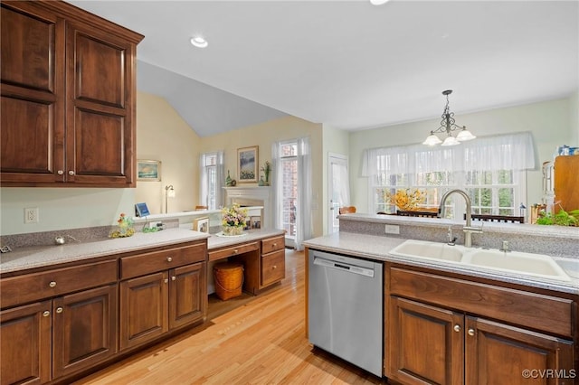 kitchen with sink, a chandelier, light hardwood / wood-style flooring, dishwasher, and pendant lighting