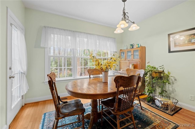 dining area featuring an inviting chandelier and light wood-type flooring