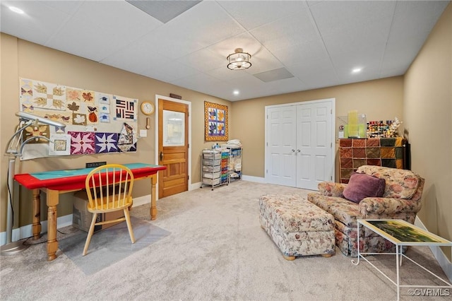 rec room with carpet floors and a paneled ceiling