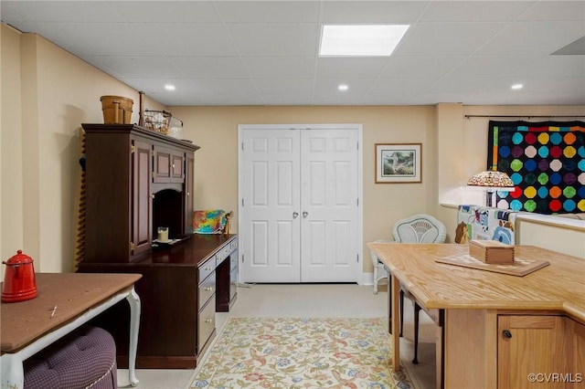 kitchen with a drop ceiling and dark brown cabinetry