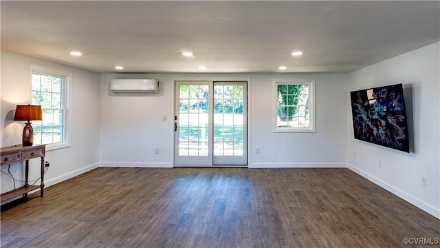 interior space featuring a wall mounted air conditioner and dark wood-type flooring