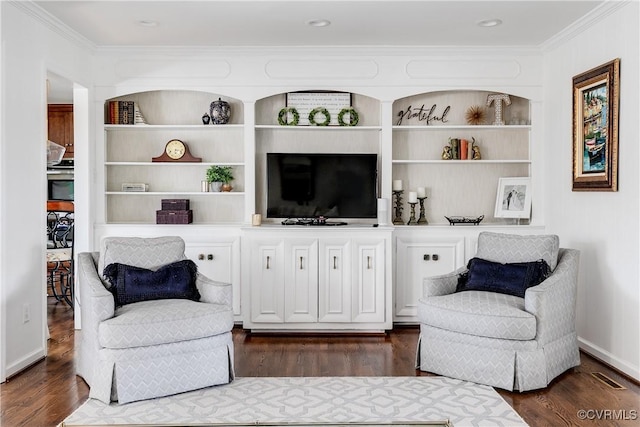 sitting room with crown molding, dark hardwood / wood-style flooring, and built in shelves