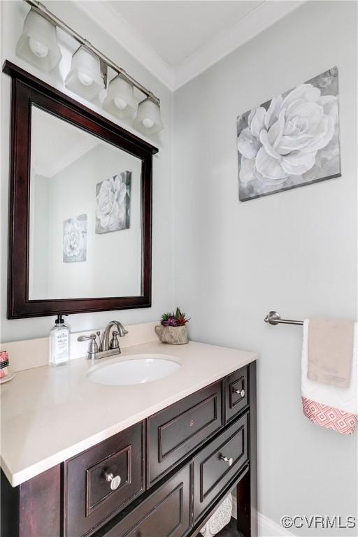 bathroom featuring vanity and ornamental molding