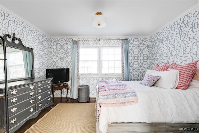 bedroom with ornamental molding and dark hardwood / wood-style floors