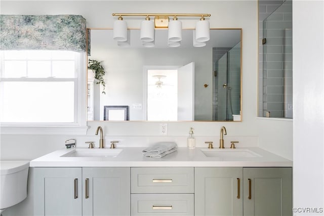 bathroom with tiled shower and vanity