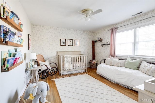 bedroom with hardwood / wood-style flooring and ceiling fan