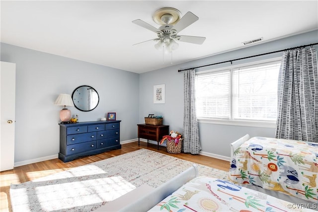 bedroom with light hardwood / wood-style floors and ceiling fan